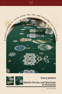 Close-up of green Christmas table runner with snowflake patterns and festive ornaments