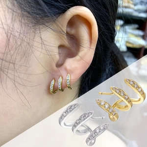 Macro shot of 18K gold and silver plated earrings with micro-set shimmering crystals