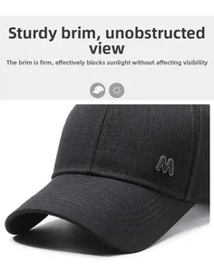 Detail of a structured black cotton baseball cap with a metal M letter decoration