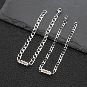 Detailed close-up of stainless steel couple bracelets with Forever and Always engraving