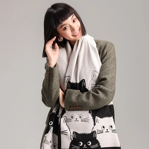 Detail of cute black and white cat pattern on a thick winter cashmere-like shawl