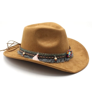 Detail of brown suede cowboy hat with bohemian fringe, beads and ethnic braided band