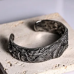 Retro stainless steel open cuff bracelet featuring detailed 3D embossed dragon patterns