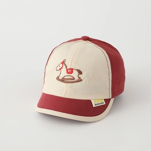 Detail of embroidered horse pattern on burgundy and beige toddler baseball cap