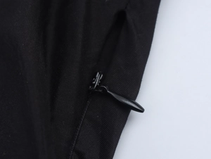 Detailed close-up of the black fabric texture and high-quality invisible zipper closure