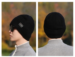 Detail view of black ribbed knit beanie with FARDI letter label and warm texture