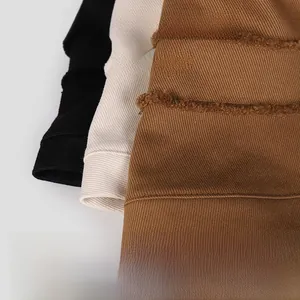 Detail of frayed edge twill cotton bucket hats in black, beige and brown colors