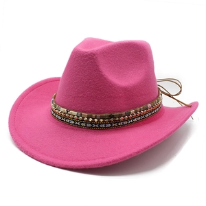 Detail of rose pink felt cowboy hat featuring a colorful ethnic beaded decorative band