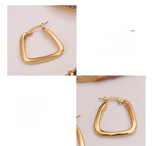 Macro detail of U-shaped geometric earrings made of 18K gold plated surgical titanium steel