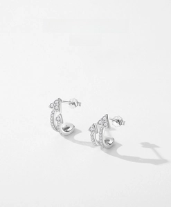 Macro shot of S925 sterling silver arrow earrings with sparkling pave zircon accents
