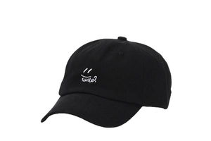 Detail of white smile embroidery on black cotton baseball cap with six-panel structure