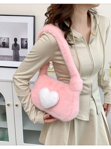 Pink plush shoulder bag with white heart detail for women in minimalist home setting