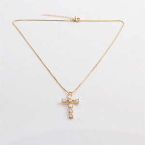 Fashionable gold chain necklace with a sparkling cross pendant on a white background