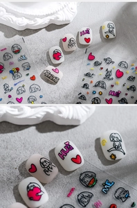 Detail of cute embossed nail stickers featuring cartoon girls and text on matte nails