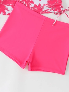 Detail of tropical palm print tankini top with adjustable drawstrings and pink swim shorts