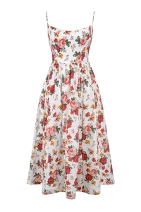 Close-up of vibrant rose floral print and delicate spaghetti straps on white midi dress