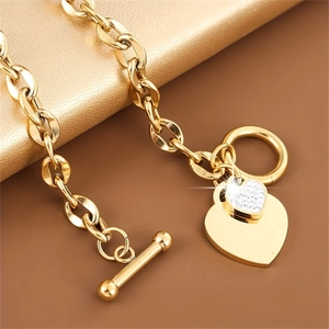 Gold stainless steel heart bracelet with sparkling rhinestones and toggle clasp for women