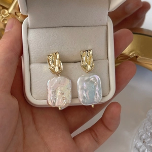 Close-up of Baroque freshwater pearl earrings with textured 14K gold plating in a gift box