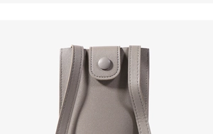 Detailed macro view of the grey mini phone bag showing fine leather texture and stitching