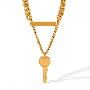 Macro view of gold stainless steel chunky chain with square plaque and key pendant detail