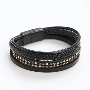 Detail of multi-layer leather bracelet with metal rivets and magnetic closure