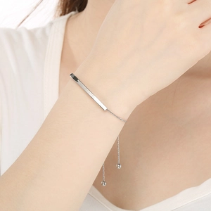 Detailed shot of silver adjustable bracelet with KEEP DREAM engraving on a metal bar