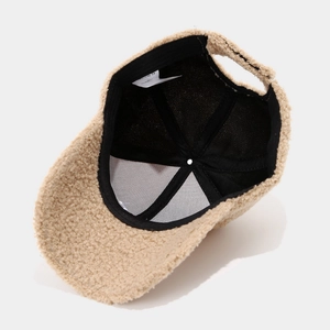 Detail view of beige Sherpa baseball cap interior showing soft lining and material tag