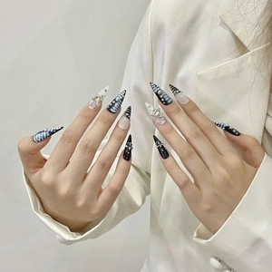 Gothic stiletto press-on nails with black and white butterfly art, silver cross, and pearls