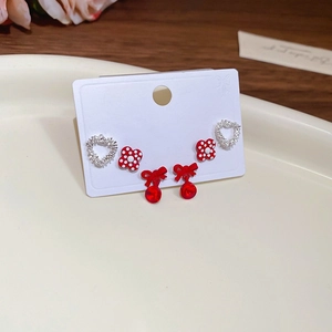 Detailed view of 6-piece earring set with silver hearts, red flowers and bow pendants