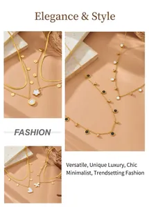 Detailed view of layered gold-tone stainless steel necklaces with clover and heart charms