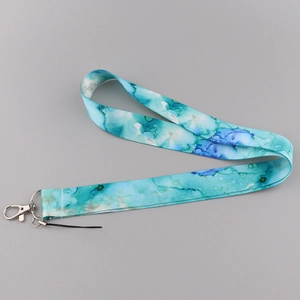 Detail shot of marble textured blue lanyard with durable metal lobster clasp and loop