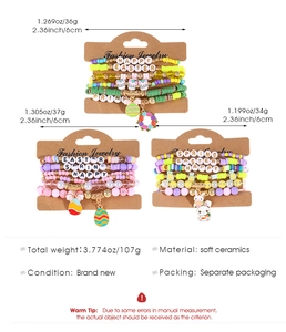 Detailed view of colorful clay bead bracelets set with Easter charms and letter beads