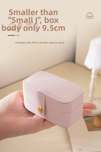 Detailed view of portable pink jewelry box measuring 9.5cm length held in hand