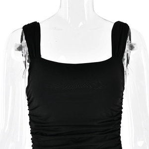 Close-up of black square-neck dress featuring elegant ruched fabric and wide shoulder straps