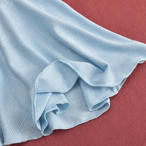 Close-up of light blue ribbed knit fabric texture and high-quality hem detailing