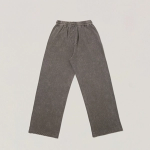 Macro view of distressed grey wide-leg pants featuring premium vertical rib texture