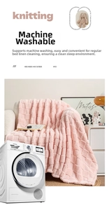 Detail of pink waffle texture blanket showing machine washable fabric on sofa