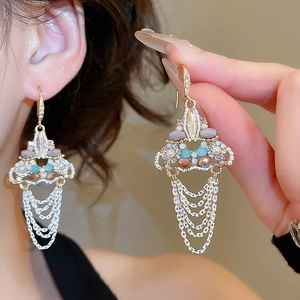 Detailed view of luxury triangle crystal tassel earrings with colorful beads and silver chains