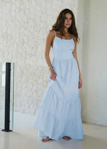 Détail de la robe longue à volants bleu clair montrant la texture légère en lin et coton