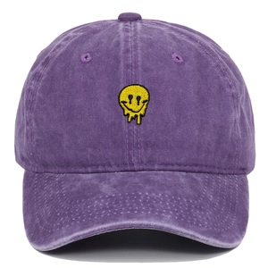 Close-up of purple washed cotton baseball cap featuring yellow melting smiley face embroidery