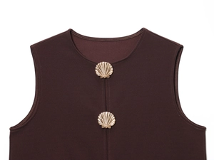 Detail view of dark brown vest featuring exquisite gold shell-shaped decorative buttons