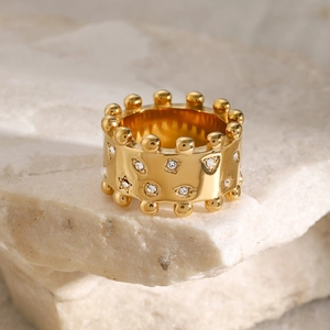 Macro shot of 18k gold plated wide ring with crystal accents and beaded edges