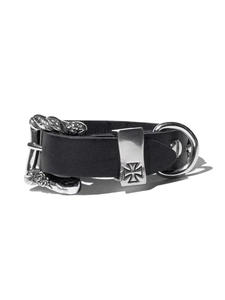 Detail of punk leather bracelet featuring silver cross studs and metallic buckle