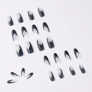 Dark baroque press-on nails featuring matte black finish and white butterfly patterns