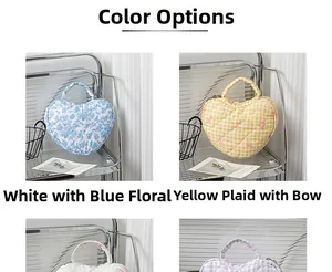 Detail of floral and yellow checkered heart quilted cosmetic bags with bow and handle