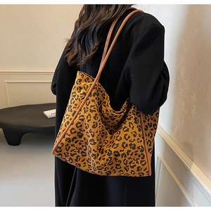 Detail view of leopard print tote bag showing spacious design and faux leather handles