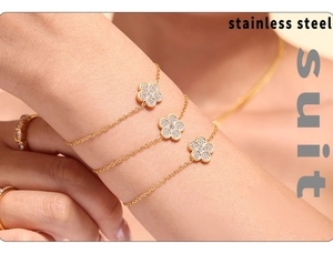 Detailed view of gold plated stainless steel four-leaf clover bracelet set with zircons