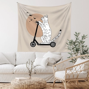 Detail of bohemian wall tapestry featuring a minimalist cat riding a scooter on fabric