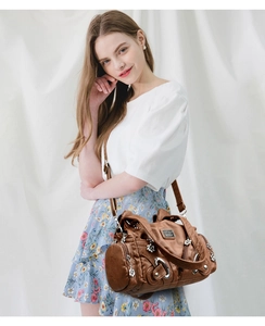 Brown vintage faux leather shoulder bag with silver hardware and adjustable strap detail