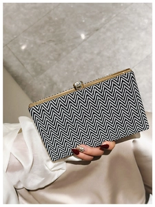 Detail of herringbone acrylic clutch with gold metal frame and crystal clasp